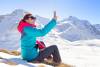young-female-taking-selfie-her-phone-beautiful-mountain-top-winter-time_156802-25